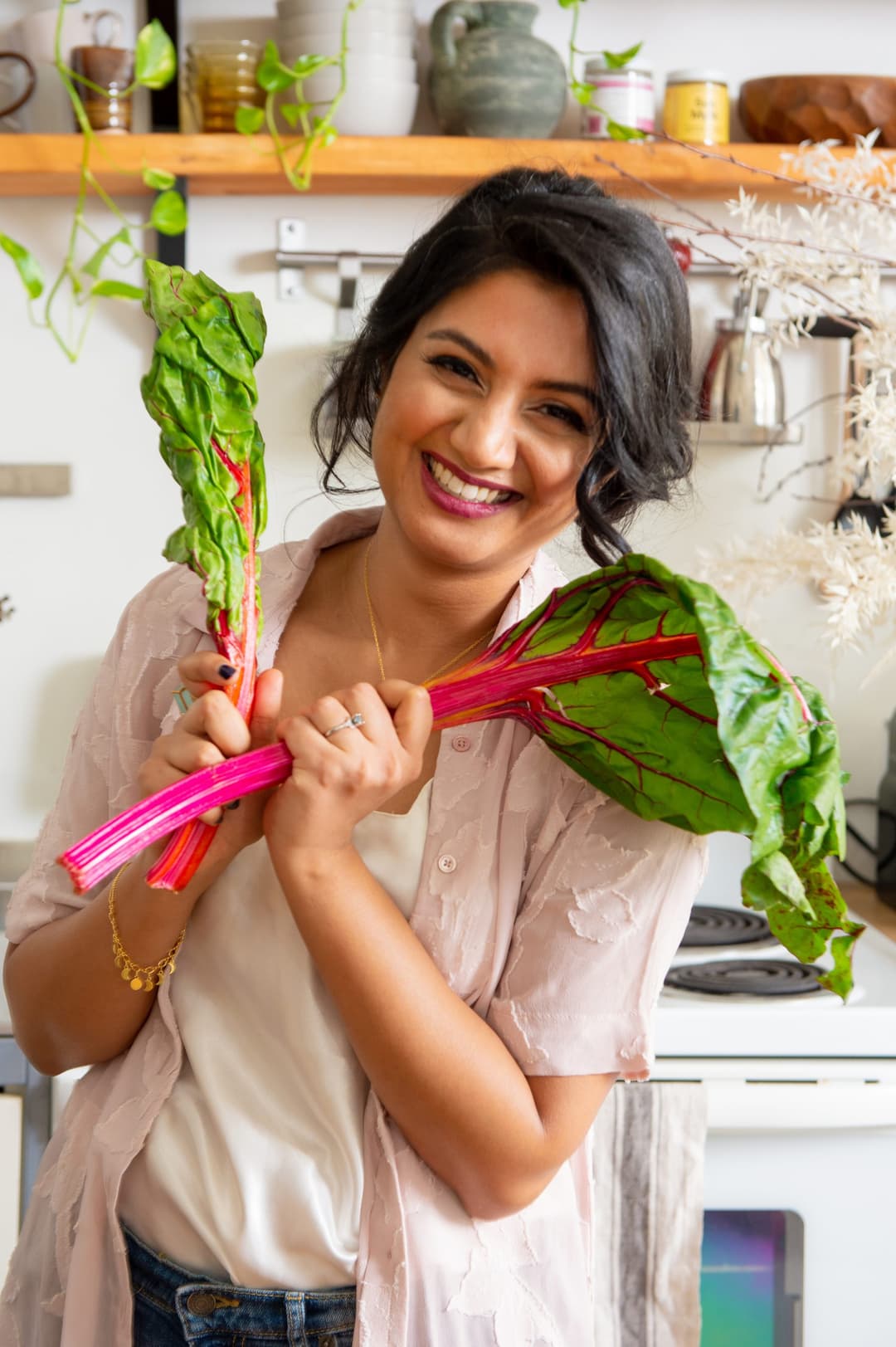 Dr. Anne smiling with fresh produce