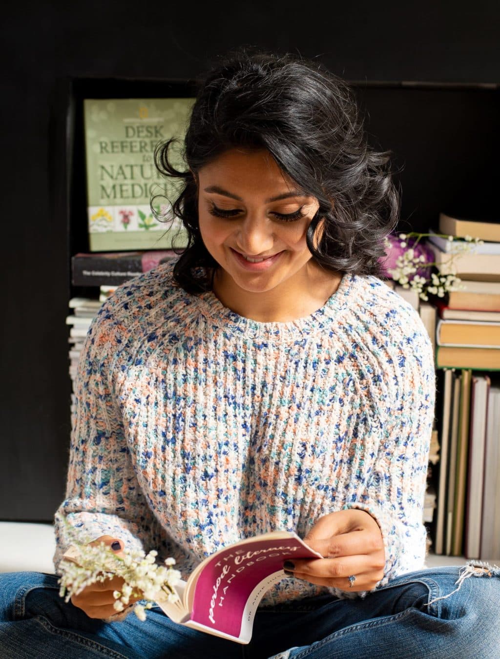 Dr. Anne reading a book on periods