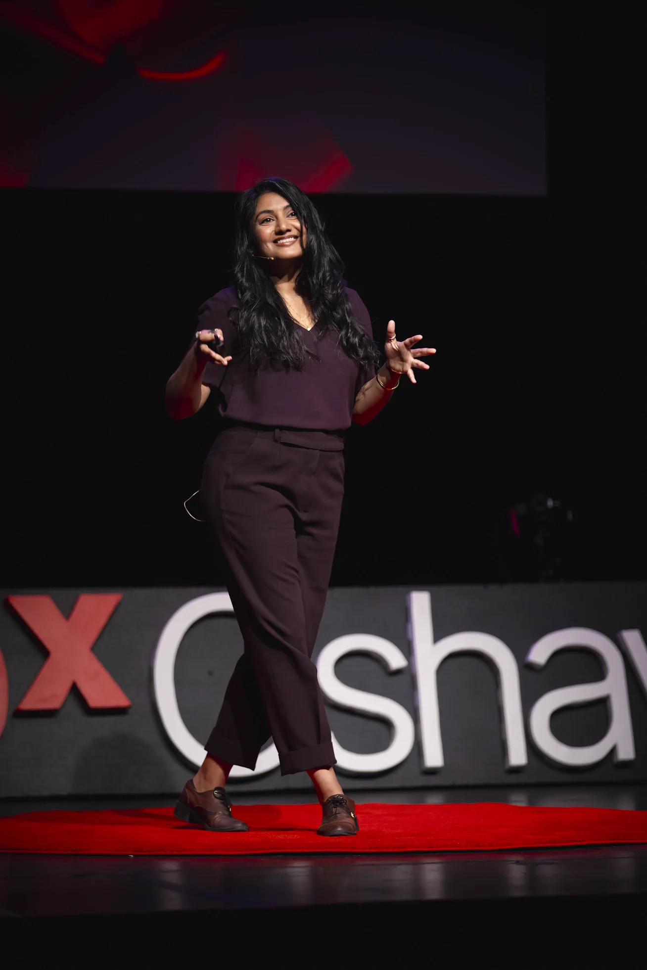 Dr. Anne Hussain on stage at TEDxOshawa