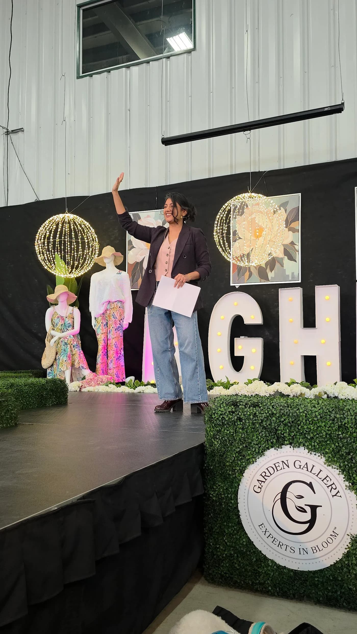Dr. Anne Hussain speaking on stage at Garden Gallery