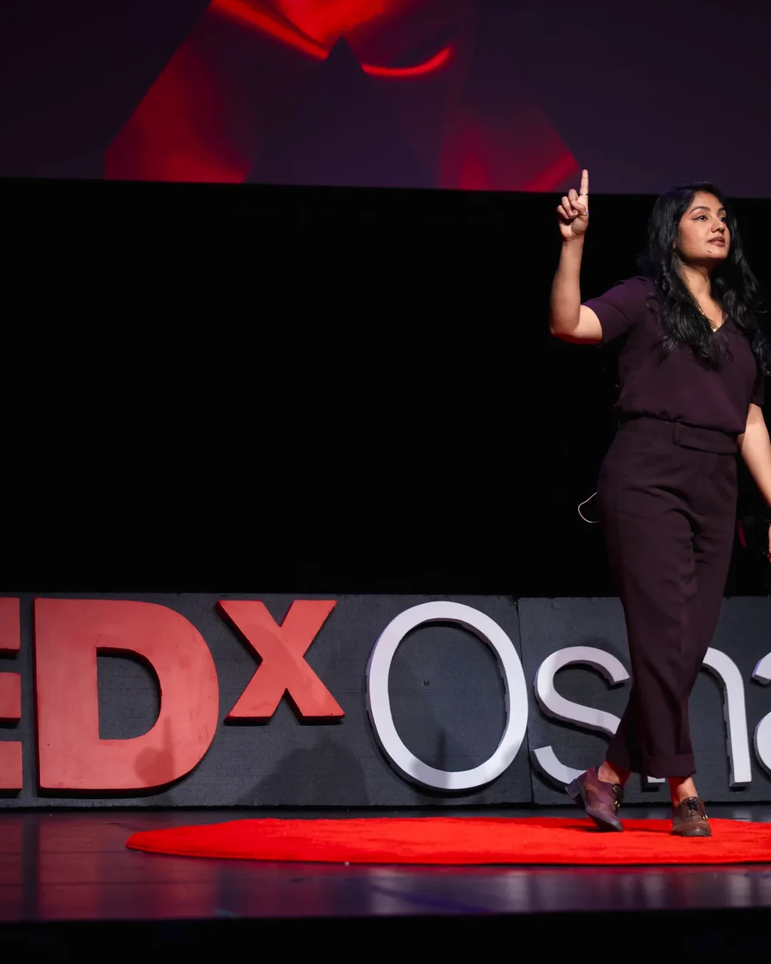 Dr. Anne Hussain speaking on the TEDxOshawa stage